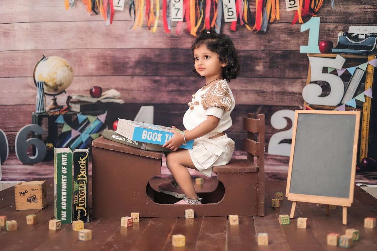 services-03 Adorable child in a classroom setting with books and educational props, creating a playful learning atmosphere.