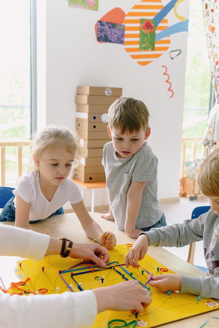 Kids collaborating on a colorful project in a bright kindergarten classroom.